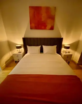 a bedroom with a large bed with two night stands at The Y Istanbul Suites in Istanbul