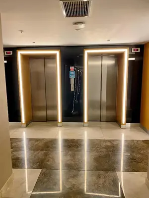 two elevator doors in a building with a tile floor at The Y Istanbul Suites in Istanbul