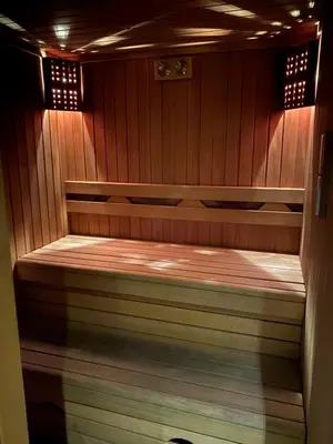 a small sauna with a wooden floor and wooden walls at The Y Istanbul Suites in Istanbul