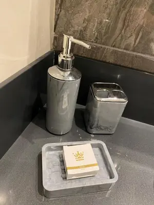 a bathroom counter with a soap dispenser and a book at The Y Istanbul Suites in Istanbul