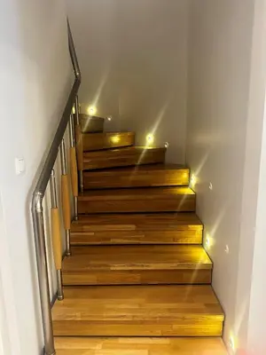 a stairway with wooden steps with lights on it at The Y Istanbul Suites in Istanbul