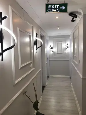 a hallway with exit signs on the walls at iNALENS AİRPORT HOTEL in Arnavutköy