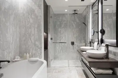 a bathroom with two sinks and a tub and a shower at JW Marriott Hotel Istanbul Marmara Sea in Istanbul