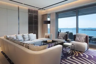a living room with a couch and chairs and windows at JW Marriott Hotel Istanbul Marmara Sea in Istanbul