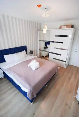 a bedroom with a large bed with a blue headboard at King Suite SS7 in Istanbul