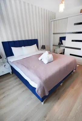 a bedroom with a large bed with a blue headboard at King Suite SS7 in Istanbul