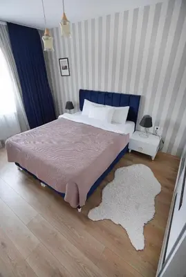 a bedroom with a large bed with a rug on the floor at King Suite SS7 in Istanbul