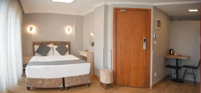 a bedroom with a bed and a wooden door at Seven Studıos Sultanahmet in Istanbul