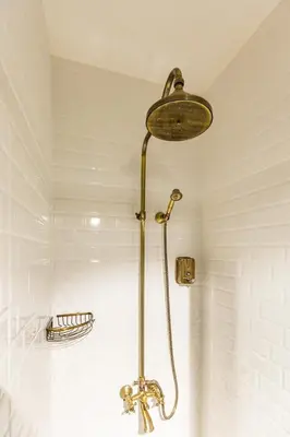 a shower with a brass shower head in a bathroom at Ganbaru Tours - Private Triplex&Duplex in Istanbul