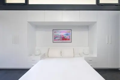 a white bedroom with a white bed with white cabinets at Bright Modern Design New Duplex Loft Patio! #145 in Istanbul