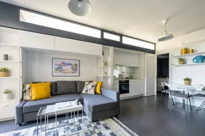 a living room with a couch and a table at Bright Modern Design New Duplex Loft Patio! #145 in Istanbul