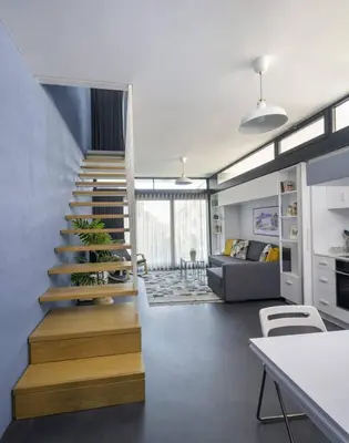 a living room with a staircase and a couch at Bright Modern Design New Duplex Loft Patio! #145 in Istanbul