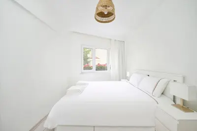 a white bedroom with a white bed and a window at Bright Modern new 1bed1bath Hidden Gem Bebek! #78 in Istanbul
