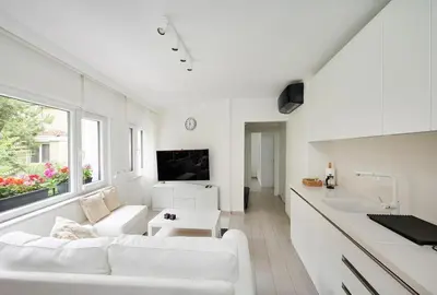 a white living room with a white couch and a table at Modern Bright Cozy 1bed1bath Hidden Gem! #79 in Istanbul
