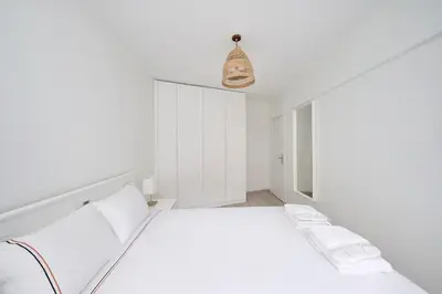 a white bedroom with a bed and a pendant light at Modern Bright Cozy 1bed1bath Hidden Gem! #79 in Istanbul