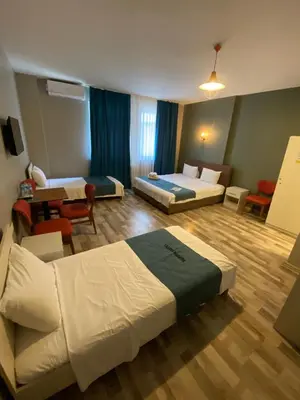 a hotel room with two beds and a living room at Puffin Boutique - Istanbul in Istanbul