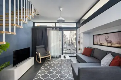 a living room with a couch and a tv at Brand New Central Modern Loft Smart Design! #144 in Istanbul
