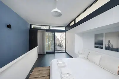 a bedroom with a white bed and a large window at Brand New Central Modern Loft Smart Design! #144 in Istanbul