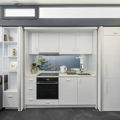 a kitchen with white cabinets and a black oven at Brand New Central Modern Loft Smart Design! #144 in Istanbul