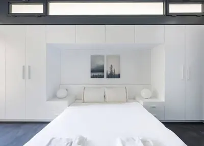 a white bedroom with a large bed with white cabinets at Brand New Central Modern Loft Smart Design! #144 in Istanbul