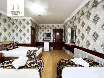 a hotel room with two beds and a tv at Orient Hotel in Istanbul