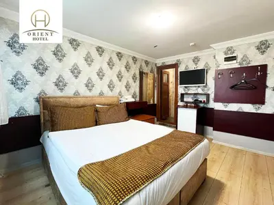 a bedroom with a bed and a television in it at Orient Hotel in Istanbul