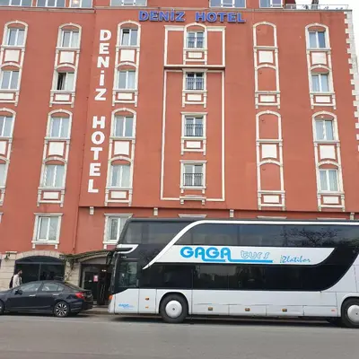 a double decker bus parked in front of a hotel at deniz otel in Istanbul