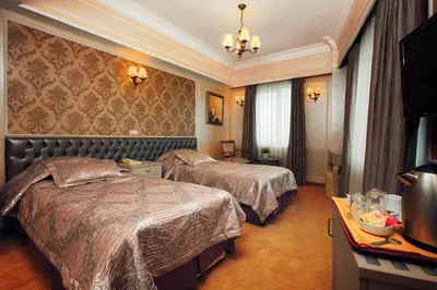 a hotel room with two beds and a television at deniz otel in Istanbul
