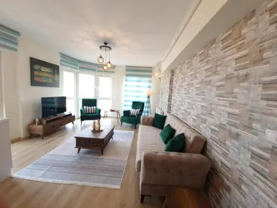 a living room with a couch and a brick wall at King Suite WH32 in Istanbul