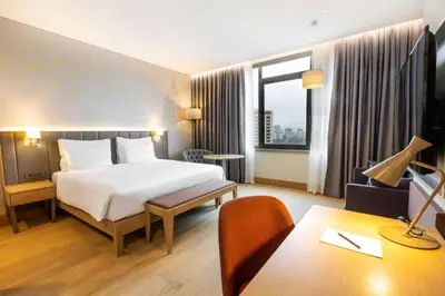 a hotel room with a bed and a desk at Radisson Hotel Istanbul Harbiye in Istanbul