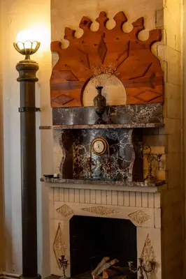 a fireplace with a wooden mantel and a fire place at Nevalist Hotel in Istanbul