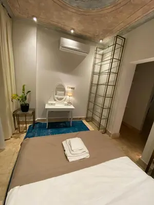 a bedroom with a bed with a dressing table and a mirror at AB Residences- Private Villa Independent in Istanbul