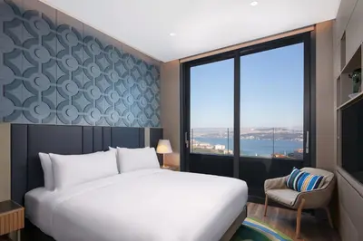 a bedroom with a bed and a large window at Lokalist, Istanbul, a Tribute Portfolio Hotel in Istanbul