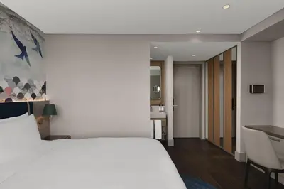 a bedroom with a white bed and a desk at Lokalist, Istanbul, a Tribute Portfolio Hotel in Istanbul