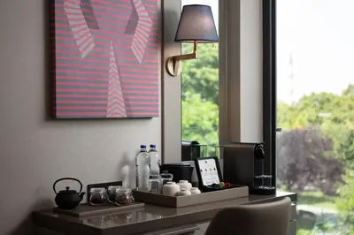a desk in a room with a lamp and a picture at Lokalist, Istanbul, a Tribute Portfolio Hotel in Istanbul