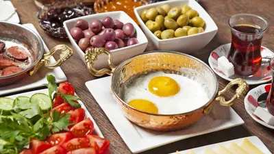 a table with an egg in a pot and vegetables at Sirin Han Hotel Old City in Istanbul