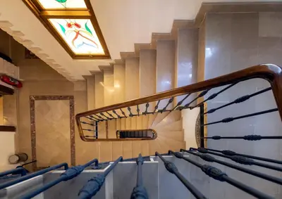 a staircase with a mirror and a stained glass window at Sirin Han Hotel Old City in Istanbul