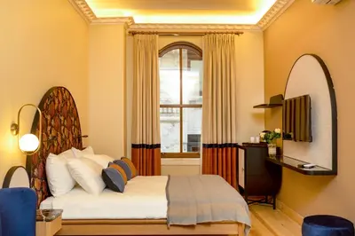 a bedroom with a bed and a window at Sirin Han Hotel Old City in Istanbul