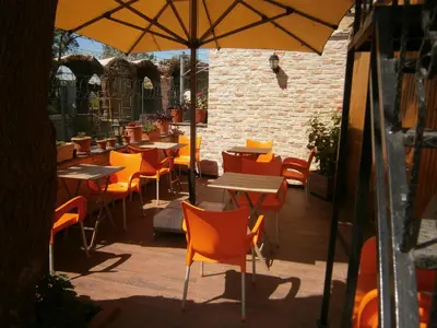 a restaurant with tables and chairs and an umbrella at Nos Istanbul in Istanbul