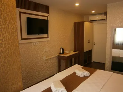 a hotel room with a bed and a flat screen tv at Nos Istanbul in Istanbul