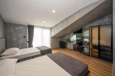 a bedroom with two beds and a large window at Continental Airport Hotel in Istanbul