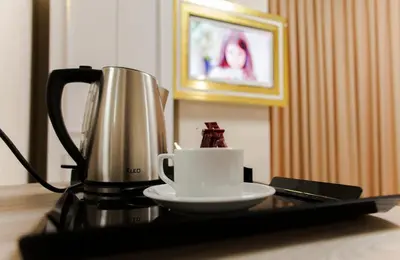 a coffee maker and a cup on a table at Continental Airport Hotel in Istanbul