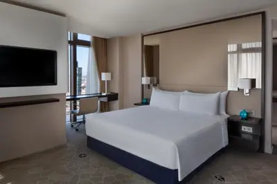 a hotel room with a bed and a flat screen tv at Istanbul Marriott Hotel Sisli in Istanbul