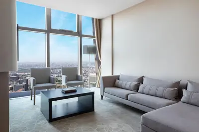 a living room with a couch and a table at Istanbul Marriott Hotel Sisli in Istanbul