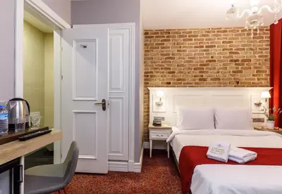 a hotel room with two beds and a brick wall at La Porte de Taksim in Istanbul