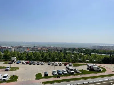 a parking lot with many cars parked in it at Agora Royal Residence in Esenyurt