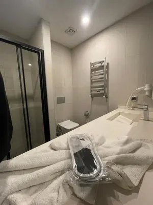 a bathroom with a sink and towels on a counter at Agora Royal Residence in Esenyurt