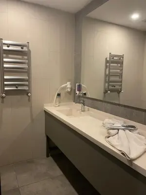 a bathroom with a sink and a mirror at Agora Royal Residence in Esenyurt