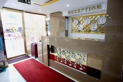 a room with a reception counter with clocks on the wall at Metrolux Hotel in Istanbul