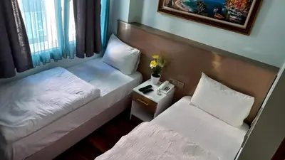 a hotel room with two beds and a phone at Metrolux Hotel in Istanbul